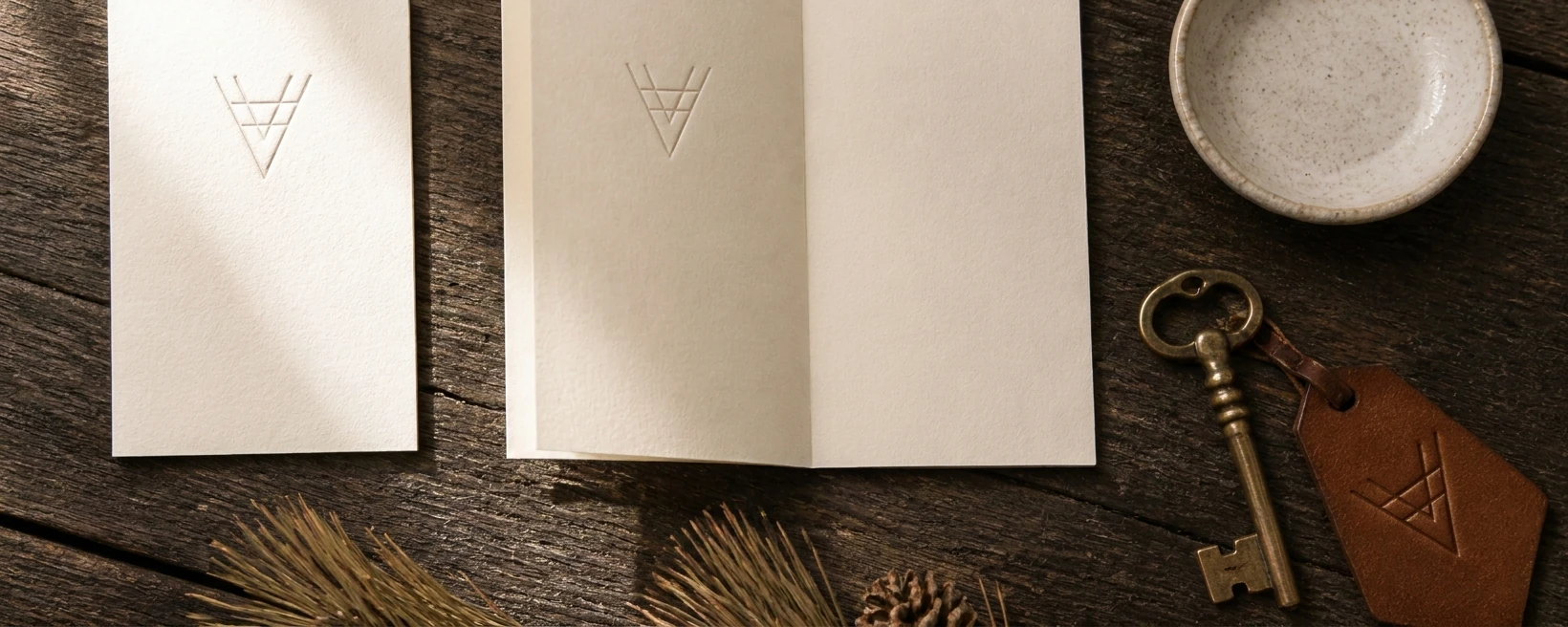 Victoria stationery suite — welcome card, key fob, and collateral